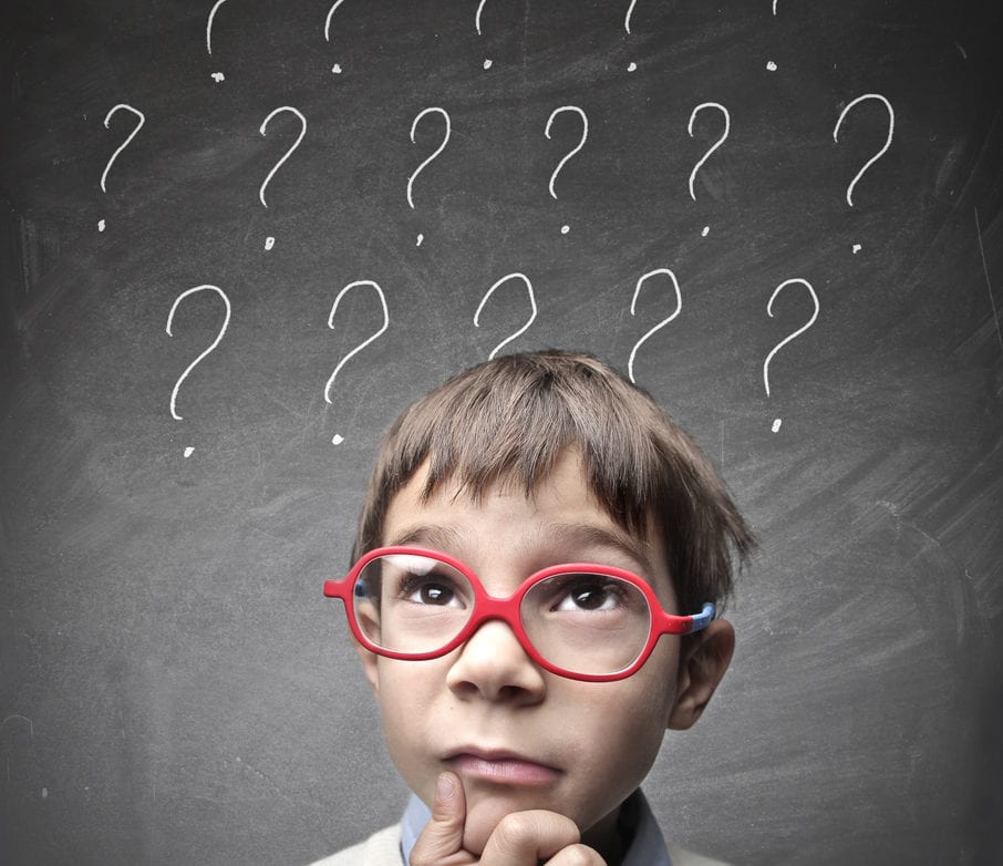 Boy with glasses and question marks