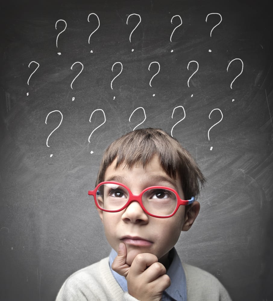 Boy with glasses and question marks