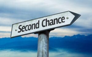 A sign on a post that says Second Chance