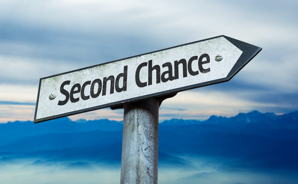 A sign on a post that says Second Chance